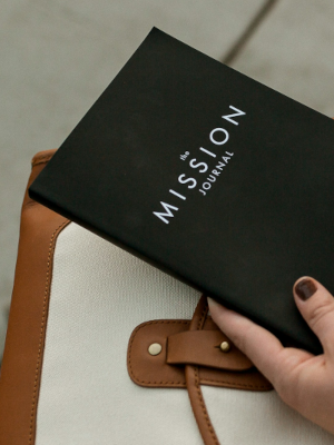 Woman holding a black book with