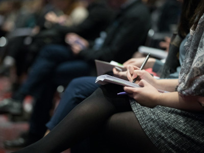 Close-up of people's legs and their notebooks in a class by the climate reality project