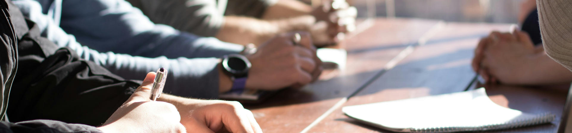 Close-up of hands on a desk by Dylan Gillis